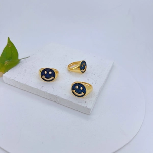 Set van drie 18k vergulde smiley ringen met blauwe zirkoon pavé op marmeren standaard
