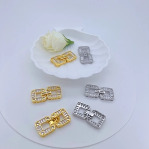 Detailed view of dual square jewelry clasps featuring micro-pave clear zircon in gold and silver