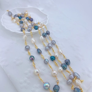 Macro shot of baroque pearls with gold-plated cubic zirconia connectors in a shell bowl