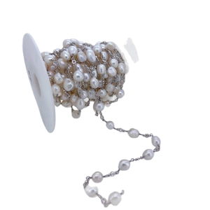 Elegant baroque pearl chain with silver connectors on a professional jewelry craft spool