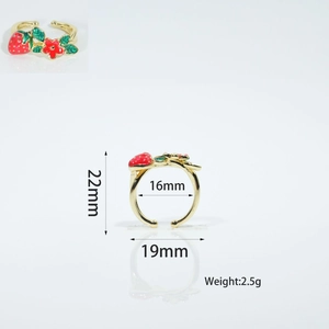 Detail view of gold-plated open ring with red strawberry and green leaf enamel charms