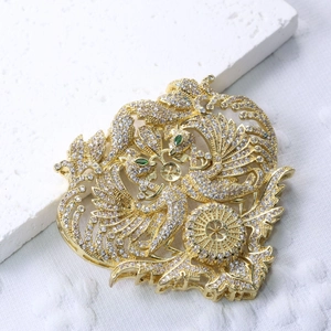 Golden phoenix brooch with pearls and tassels set with sparkling zircons and green stones