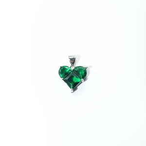 Macro view of heart-shaped green zircon pendant with silver four-prong setting