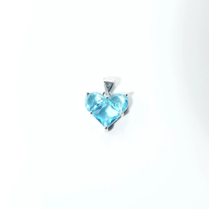 Macro shot of heart-cut blue zircon pendant with elegant silver prong setting details