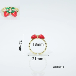 Detail view of gold-plated strawberry adjustable ring with red enamel and beaded texture