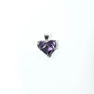 Close-up of a purple heart zircon pendant with silver-plated claw setting detail