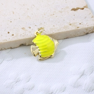 Macro shot of tropical butterfly fish pendant in gold plated copper with yellow enamel
