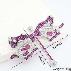 Luxurious dragonfly brooch with pink stones and crystals on elegant stone pedestal