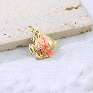 Detail of a tropical fish pendant in gold metal with gradient orange enamel finish
