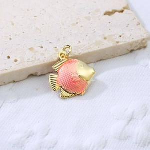 Macro shot of gold-plated fish pendant with pink-orange enamel scales and fine details