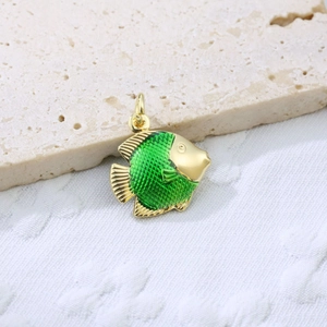 Detailed close-up of a gold-plated fish pendant featuring green enamel scales on stone