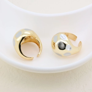 Detail of two-tone open ring with thick gold band and silver polka dot texture