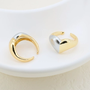 Close-up of dual-tone 18K plated geometric open rings in gold and silver finish