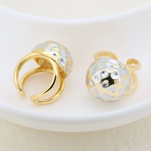 Close-up of dual-tone hammered gold and silver open ring with a domed texture design