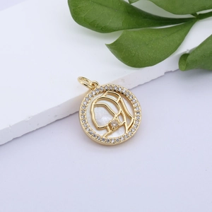 Detail of gold pendant with mother of pearl shell and cubic zirconia stones