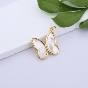 Detailed close-up of butterfly pendant with white shell inlay and gold-plated frame