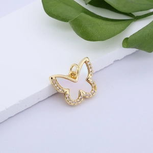 Macro detail of gold-plated butterfly pendant with shell inlay and cubic zirconia stones