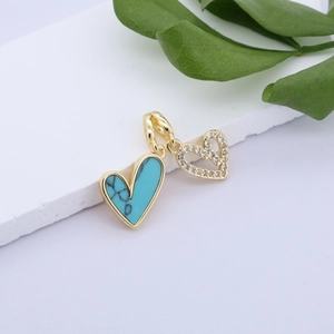 Detail of gold-plated double heart pendant with turquoise marble and zircon pavé stones