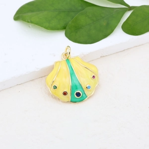 Macro detail of gold-plated seashell pendant with colorful enamel and inlaid zircon stones