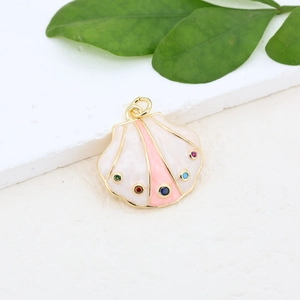 Detailed close-up of shell pendant with gold plating and colorful gemstones