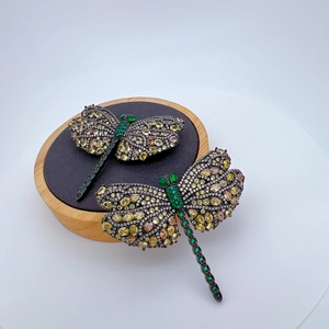 Luxury dragonfly brooch with yellow cubic zirconia and green gemstones on metal base
