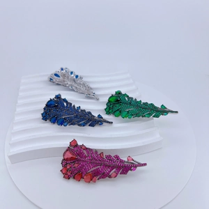 Vue détaillée de broches en forme de plumes avec zircons en quatre couleurs variées