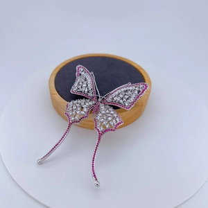 Elegant silver butterfly brooch with sparkling white and purple cubic zirconia stones