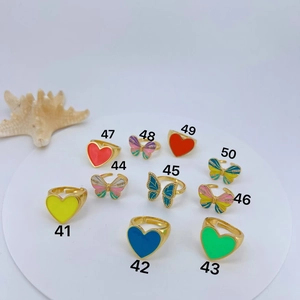 Enamel heart and butterfly adjustable rings in various colors on a white pedestal