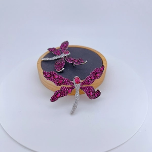 Exquisite silver dragonfly brooches with rose pink crystals and zircons on black velvet display