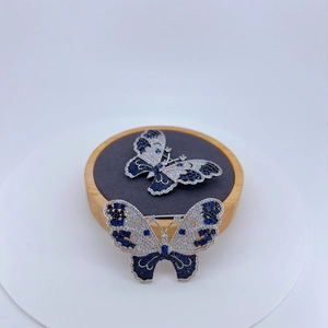 Elegant butterfly brooches with silver finish and pavé-set blue and white cubic zirconia