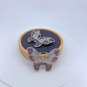 Elegant butterfly brooch with pink and white cubic zirconia on silver-tone base