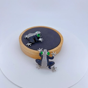 Exquisite silver frog brooch set with blue micro-pave zircons and green gemstone eyes