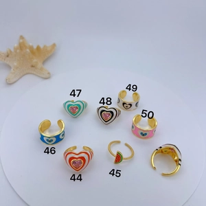 Detailed view of enamel evil eye and heart open rings with colorful zircon inlays