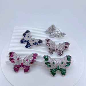 Detailed view of butterfly jewelry brooches in various colors with zircon inlay