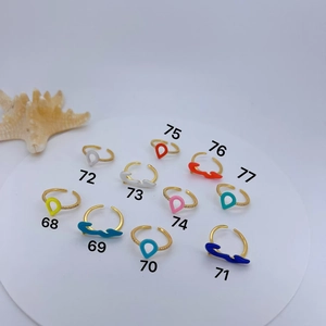 Collection of gold-plated enamel open rings with micro-pave zircon on white stand