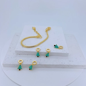 Gold snake chain bracelet set with green enamel Christmas tree charms and festive elements