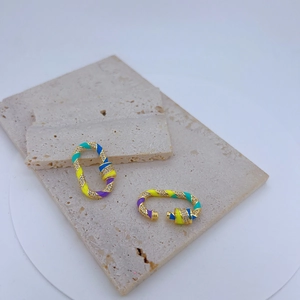 Macro detail of multicolored enamel and zircon pavé screw clasp for jewelry making