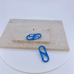 Pair of blue matte S-shaped dual spring carabiners on stone displays for keychains