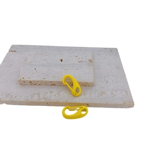 Pair of yellow spring-loaded lobster hooks on stone base for DIY jewelry making