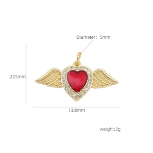 Detail view of a 13.8mm gold-plated heart pendant with red enamel and zircon wings