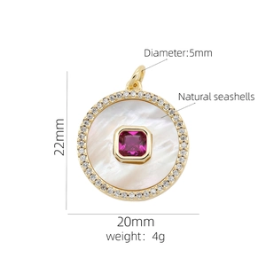 Detail of 18K gold heart pendant with natural seashell and red gemstone inlay