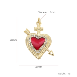 Detail view of 18k gold plated heart pendant with red enamel, zircons and Cupid arrow