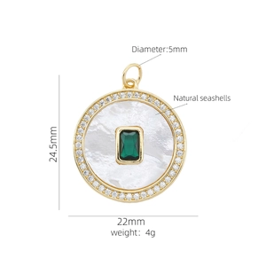 Detail of 18K gold plated pendant with green gem, white shell inlay and zircon border