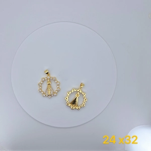 Macro shot of gold Nossa Senhora Aparecida pendants with sparkling cubic zirconia inlay