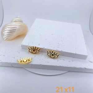 Detailed view of three 21x11mm gold evil eye pendants with cubic zirconia on stone tray