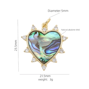 Detailed view of heart pendant with natural abalone shell and sparkling crystals