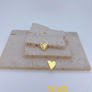 Detailed view of two gold heart pendants with hammered texture and engraved lettering