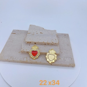 Gothic gold heart wings pendant with red enamel and crystals on stone background