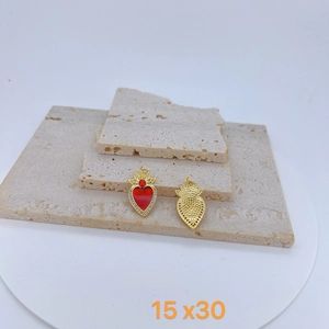 Detailed view of red heart angel wing charms with crystal inlay and crown top