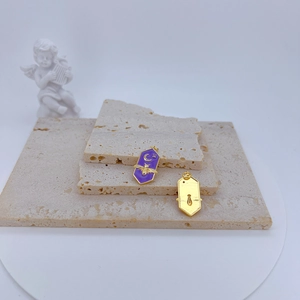 Golden bee and moon purple enamel charms on stone displays for jewelry making